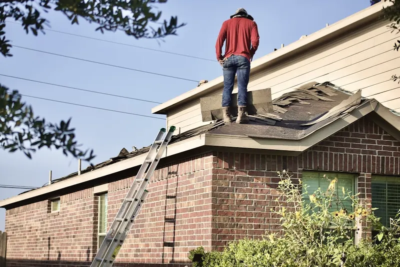 Professional roofer working on a residential roof in Distant Island